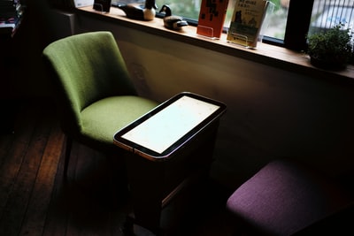 靠窗的桌子前的绿色椅子